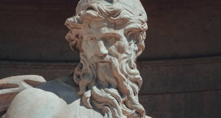 Statue of a bearded man on a fountain.