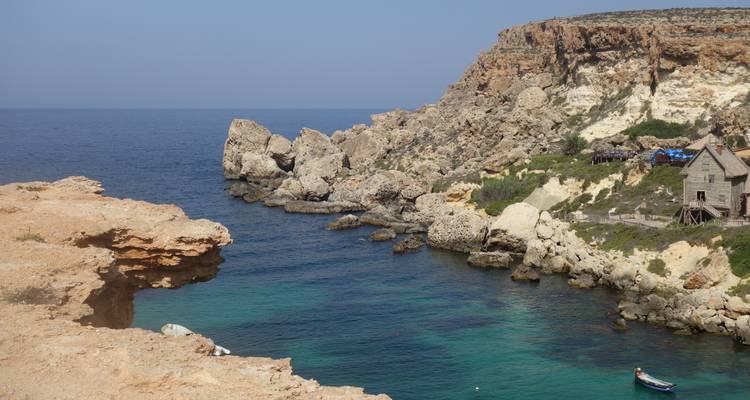 Rocky cove with clear water and scenic views.
