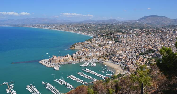 Panoramic view of a coastal town with a marina.