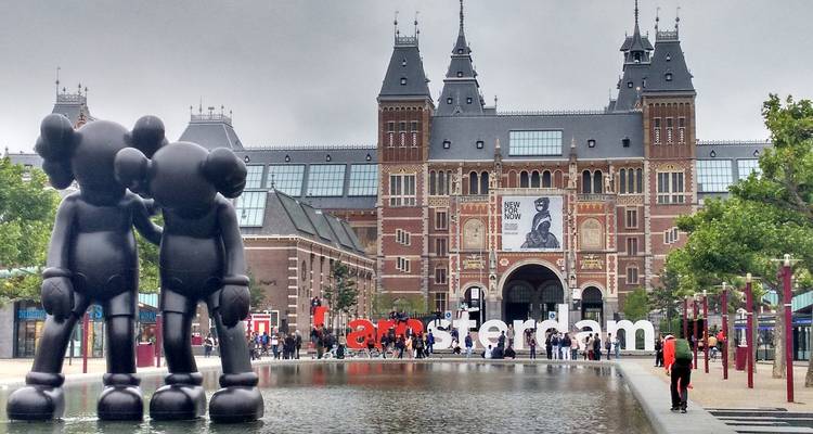 View of Rijksmuseum and 'I amsterdam' sign with sculptures.