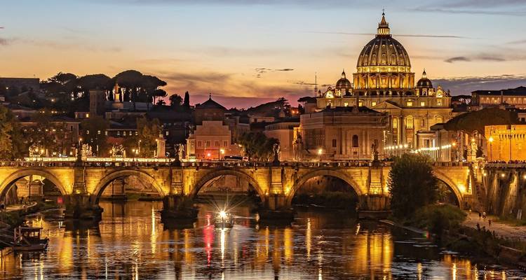 St. Peter's Basilica at dusk with reflections on the river.