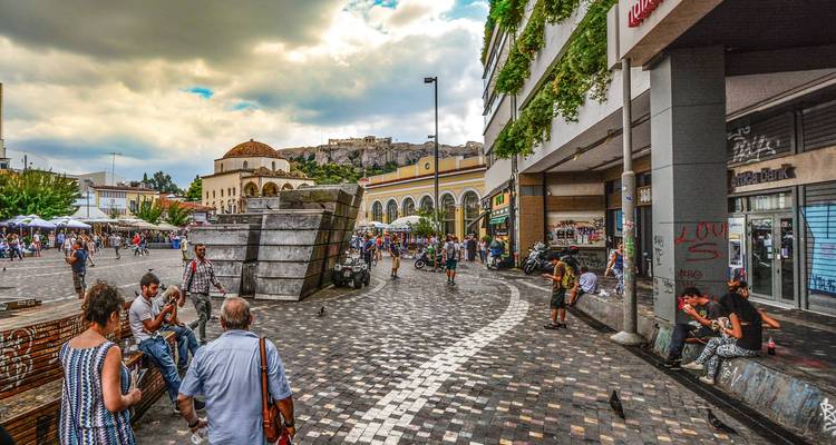Monastiraki Square in Athens with people and market stalls.