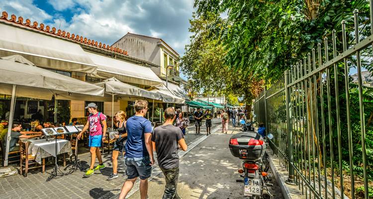 Street scene in Athens with cafes and people walking.