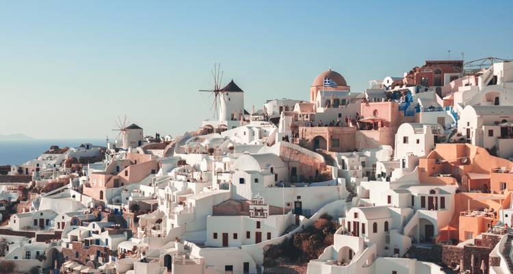 Iconic view of Santorini with white buildings and blue domes.
