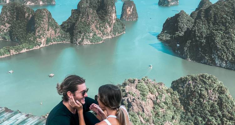 Couple posing with Halong Bay in background.