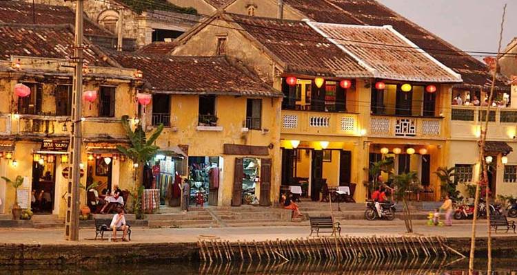 Yellow and brown buildings by a waterfront in a historic town.