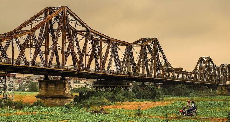 Large bridge with intricate lattice design over a river.