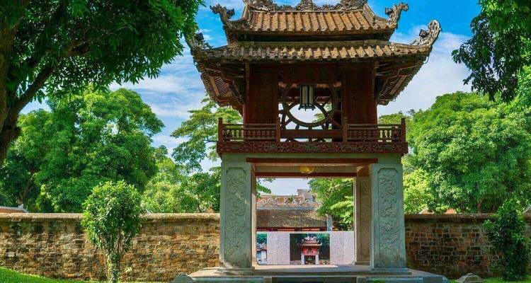 Ancient gate with detailed architecture in a garden.
