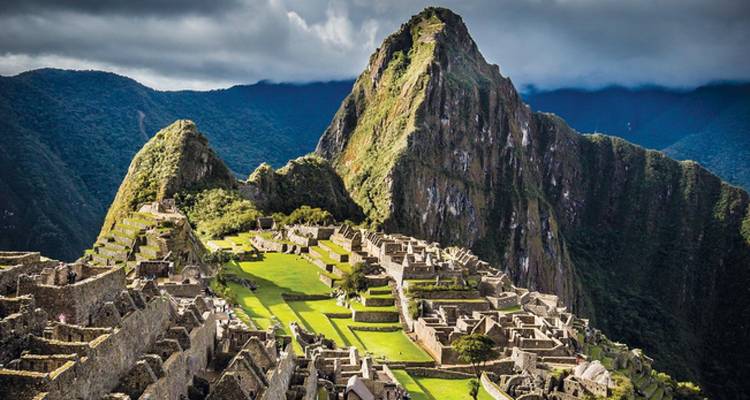 Panoramisch uitzicht op Machu Picchu met dramatische luchten.