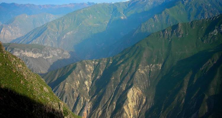 Canyon aux parois rocheuses escarpées sous un ciel dégagé.