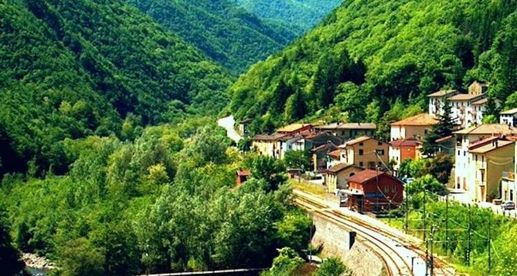 Bergdorp met groene omgeving en een slingerende weg.