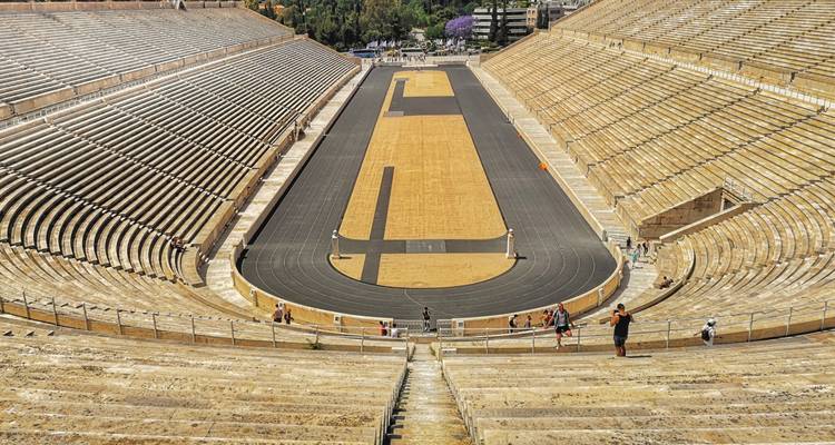 A historical stadium with people exploring.
