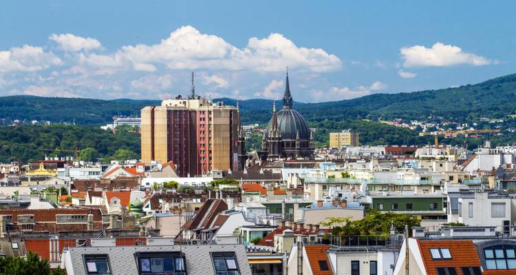 Panoramic view of a city with a mix of modern and historic architecture.