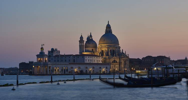 Famous basilica by a canal at sunset.