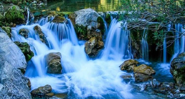 Waterfall with flowing water in a forest setting.