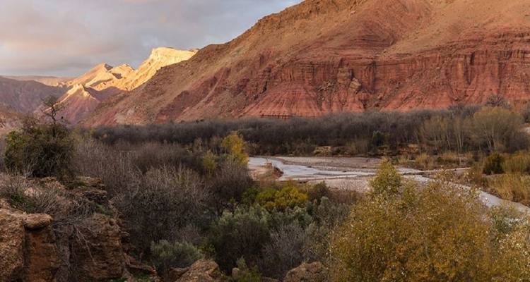 Rugged valley with red rock formations.