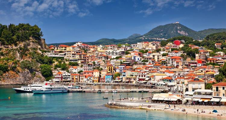 Colorful coastal town with boats in the harbor.