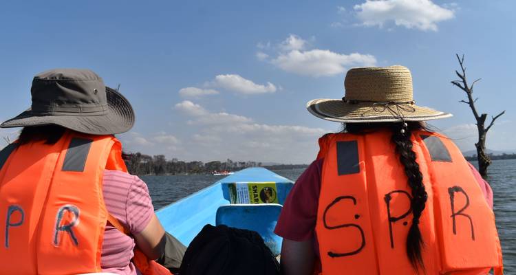 Touristen sitzen in einem Boot und genießen eine Fahrt auf dem Wasser.
