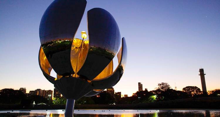 Floralis Genérica sculpture in Buenos Aires at night with city skyline.
