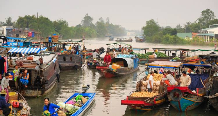 Floating market with boats and vendors.