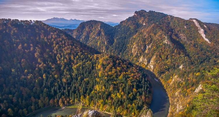 Aerial view of a winding river through mountains.