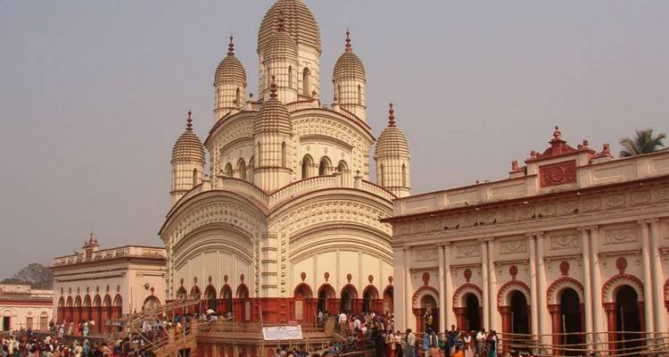 Temple with multiple domes and a crowd of people.