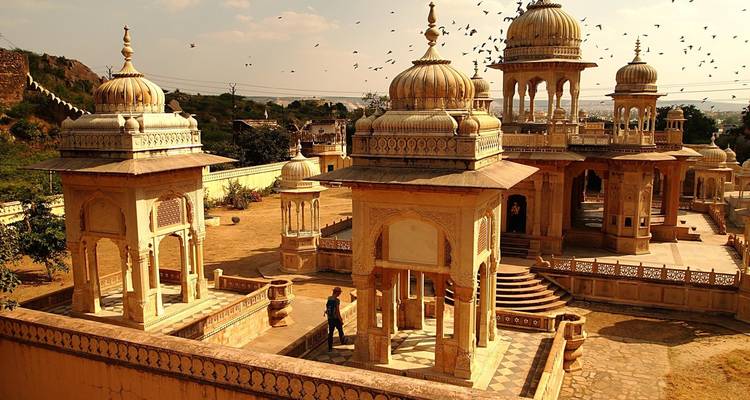 Temple with domes and arches in a serene setting.