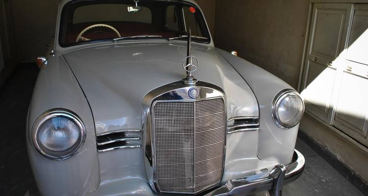 Vintage car in a dimly lit garage.