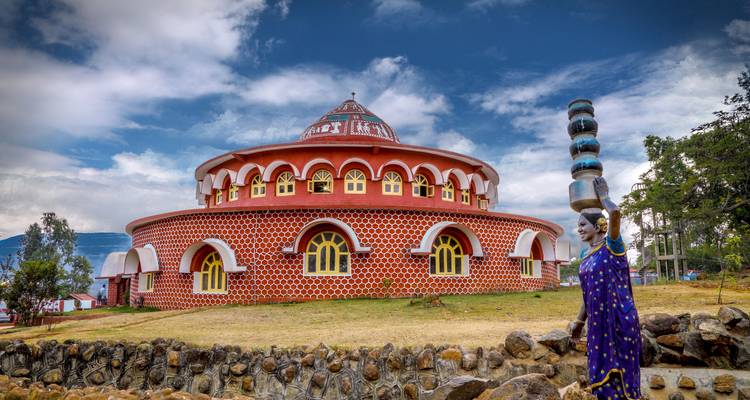 Colorful circular building with a statue.