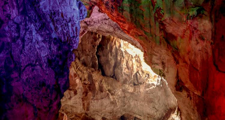 Vividly lit cave interior with colorful lighting.