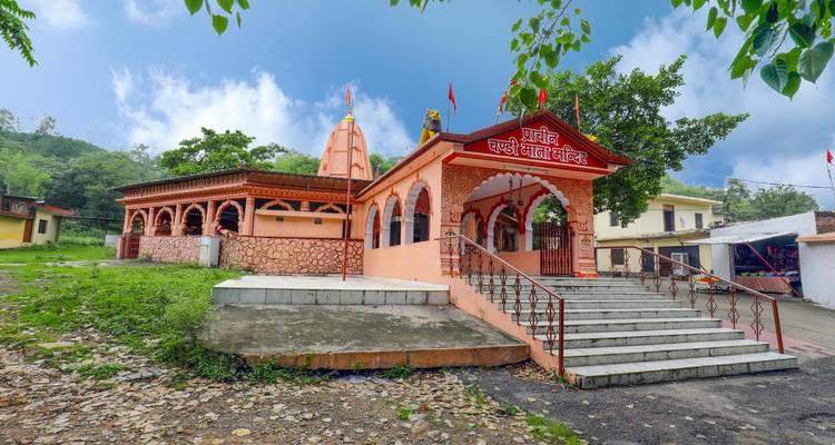 Colorful temple with stairs leading up to it.