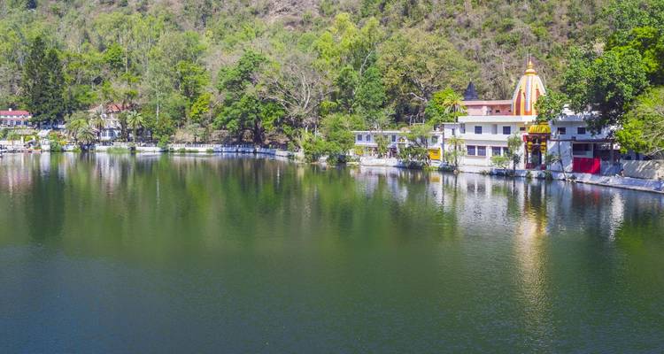 Serene lake with buildings along the shoreline.