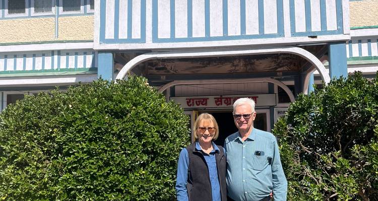 Couple in front of a building entrance.