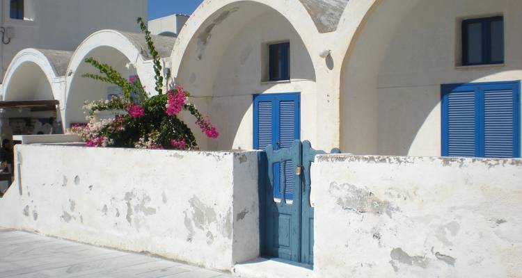 Edificios griegos tradicionales con techos arqueados y acentos azules.