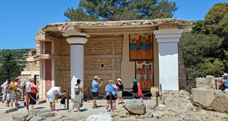 Tourists exploring the reconstructed ruins of Knossos Palace on Crete.