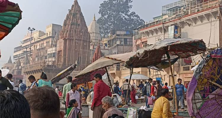 Busy street area with buildings and people.