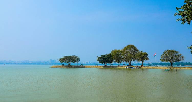 Vista serena del lago con árboles en la distancia.