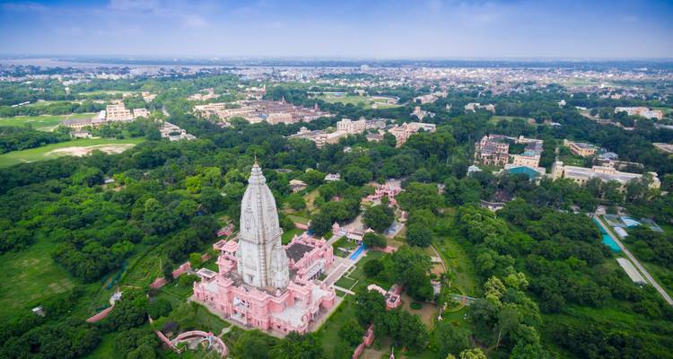 Aerial view of a city with lush greenery and a large temple