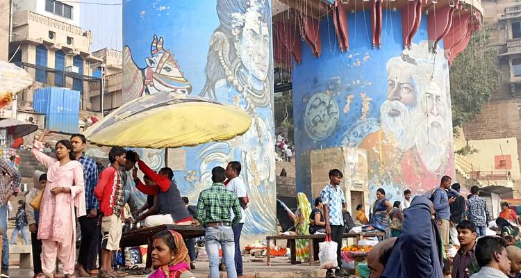 Colorful pillars with murals and people gathered around