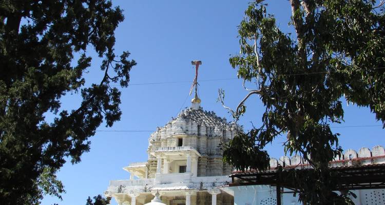 White temple roof through trees.