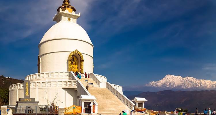 World Peace Pagoda in front of mountains in Nepal.