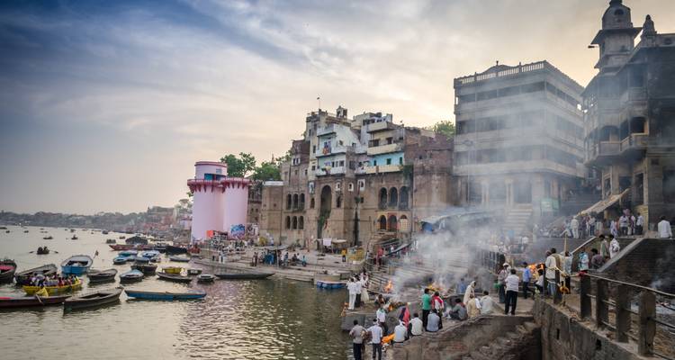 Riverfront in Varanasi with boats and people.