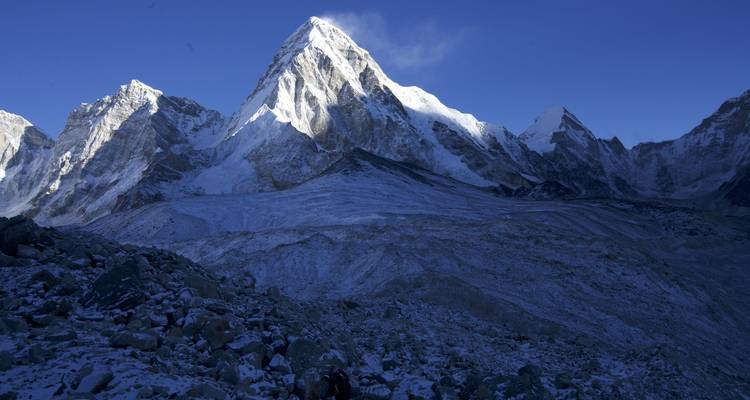 Verschneiter Berggipfel unter einem klaren blauen Himmel.