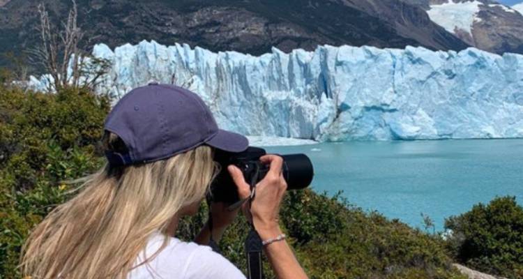 Person photographing the Perito Moreno Glacier.