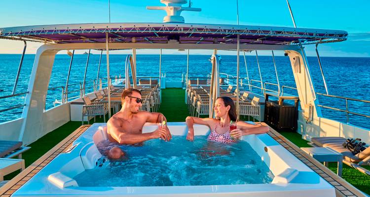 Pareja disfrutando de un jacuzzi con vista al mar abierto