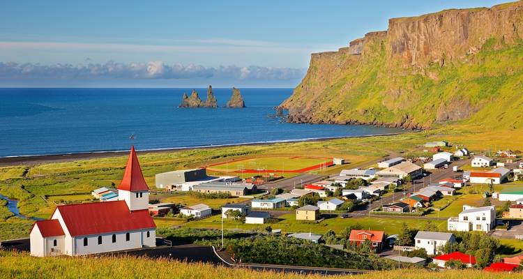 Vik with church and sea stacks in view.
