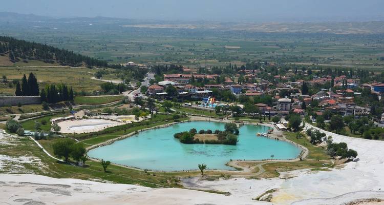 Aerial view of a town with unique turquoise pools.