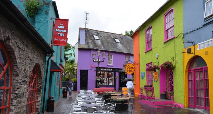 Vibrant street with colorful facades and outdoor seating.