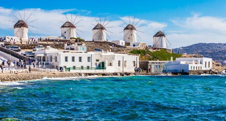 Famous windmills on a coastal hillside with the sea visible.