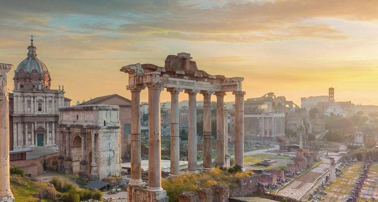 Sunrise casts golden light over the ancient columns and ruins of the Roman Forum.